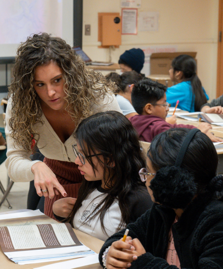 a teacher instructing two students