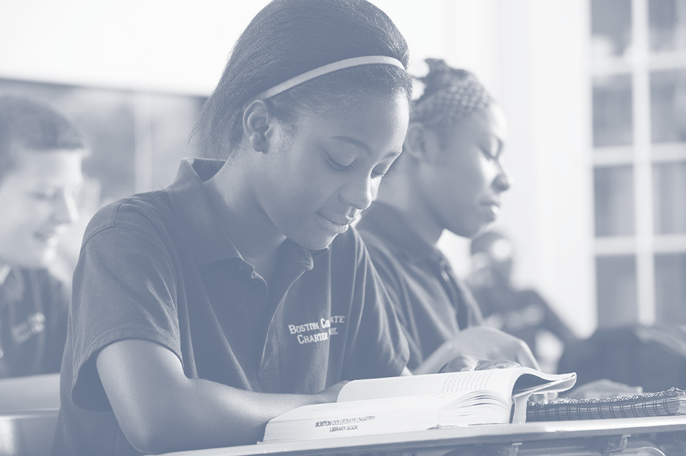 A student at a desk leaning over their desk