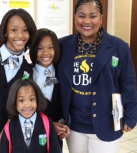 A teacher next to three young students