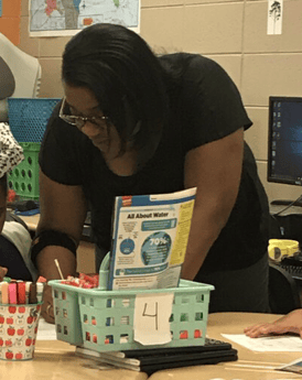  West End Academy in Birmingham, Principal Dr. Chandra Watkins leaning over a desk writing